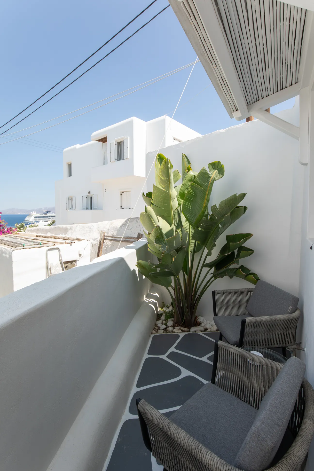 Private terrace with armchairs and banana plants